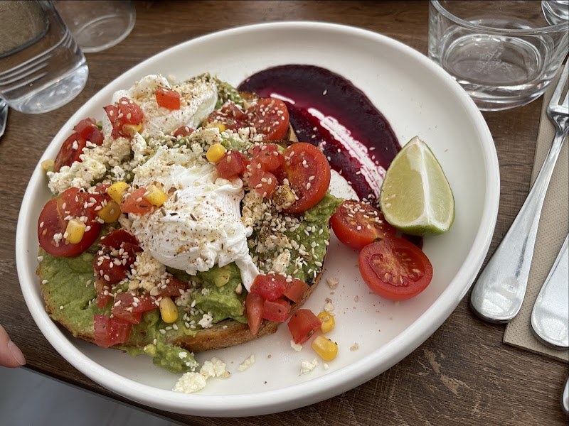 Smashed avocado on sourdough with egg, feta and beetroot purée